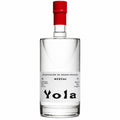 A clear glass bottle of Yola Mezcal with a white label and a bright red cap, set against a plain white background.