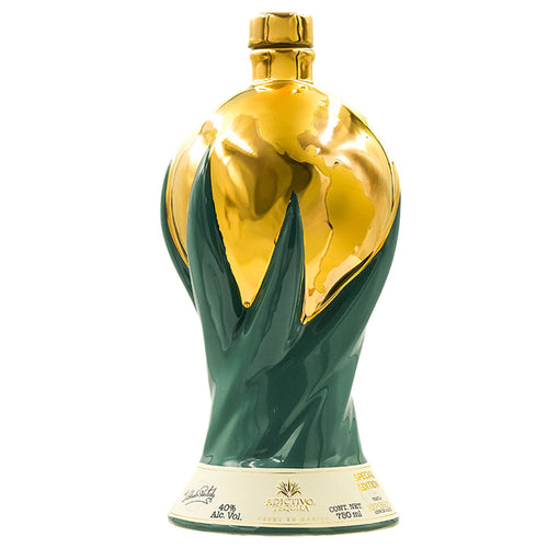 Gold and green Adictivo Doble Reposado Tequila bottle with a white background