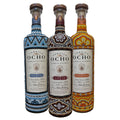 Three bottles of Tequila Ocho Huichol Art Edition with decorative labels on a white background